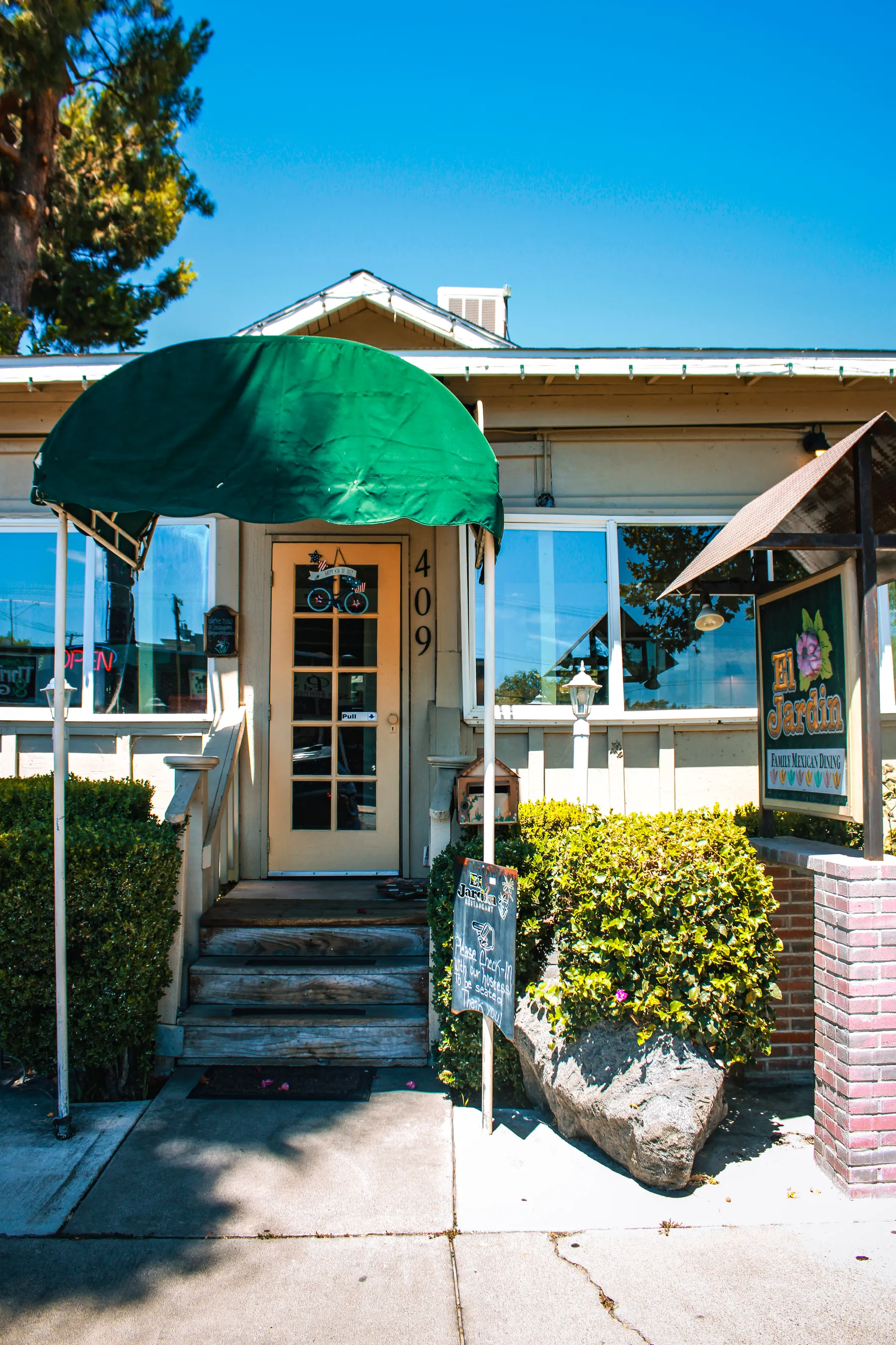 El Jardín's entrance with its green scalloped awning at 409 E Olive Ave